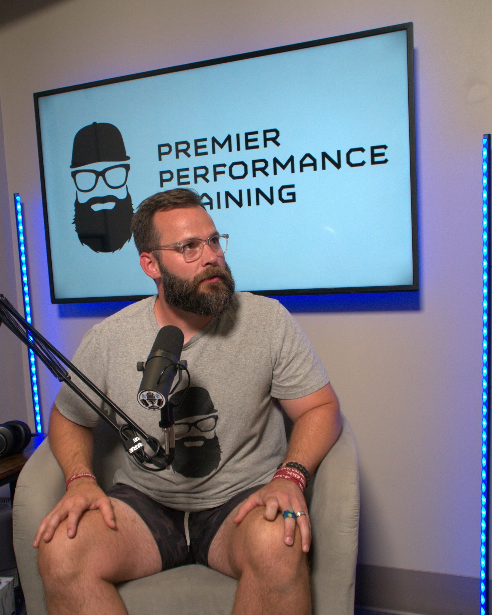 Coach Aaron Hines at a podcast microphone